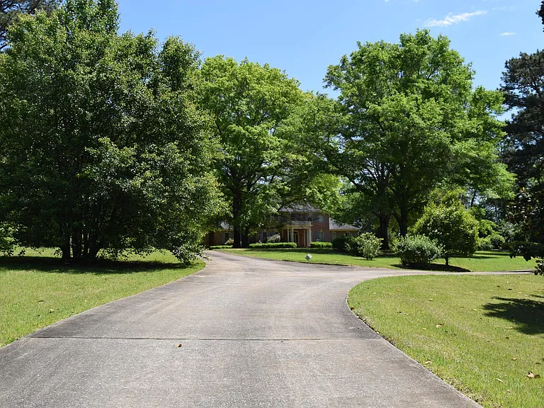 Circular drive way. Surrounded by open spaces....