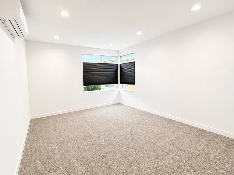 The primary bedroom has corner windows with great natural light and blackout shades for when you want to get that extra sleep!