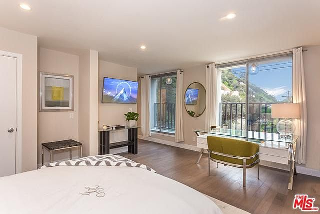 2 huge windows and mini balconies offer peaceful private views and light