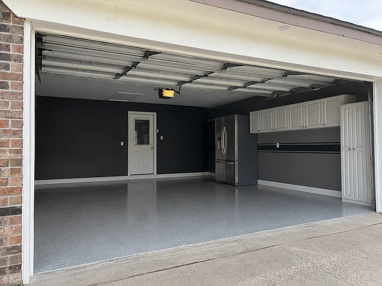 Two-car garage with built-in cabinets.