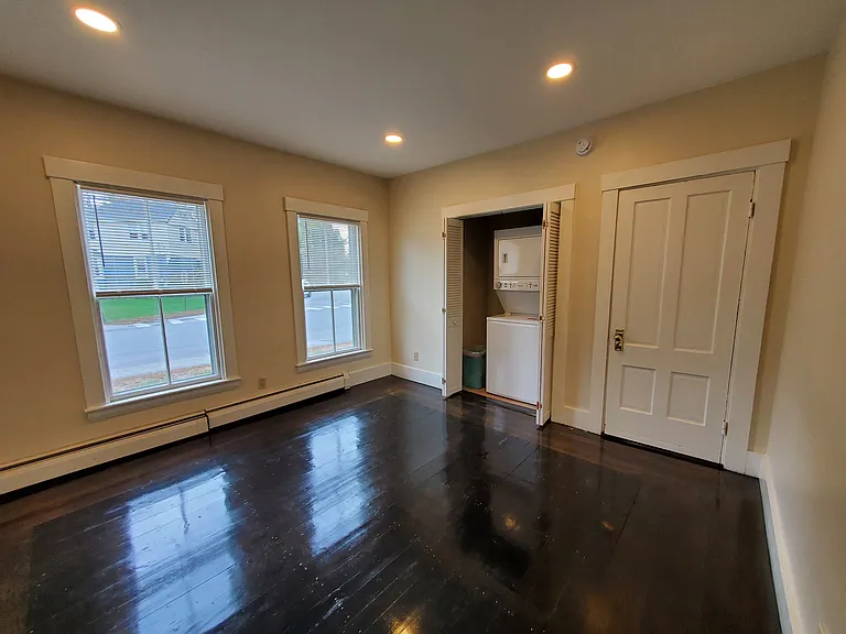 Front room with laundry center and closet