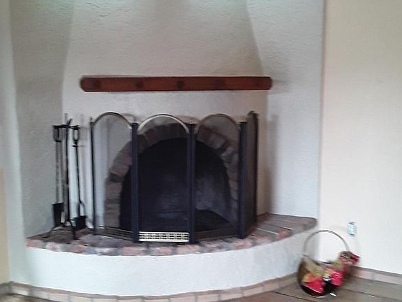 Fireplace freshly painted, room has higher vaulted ceiling, walls were painted, flooring polished up since this pic.
