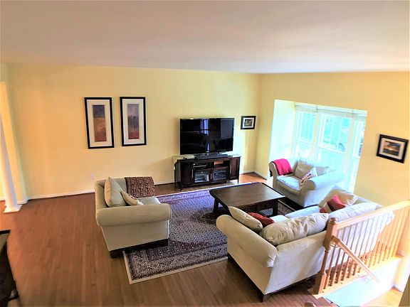 Spacious living room with lots of natural light, hardwood floors, new windows throughout entire house