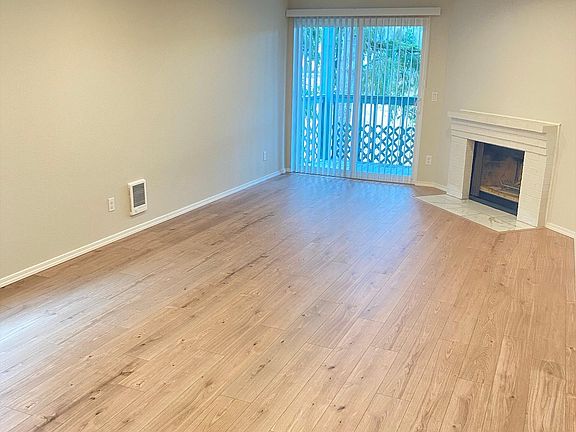 Spacious living room with all new paint and flooring. Wood burning fireplace.