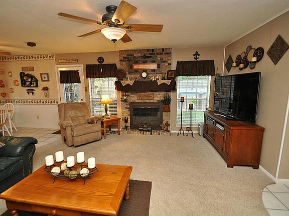 Brick fireplace is a beautiful focal point and outlined with windows.