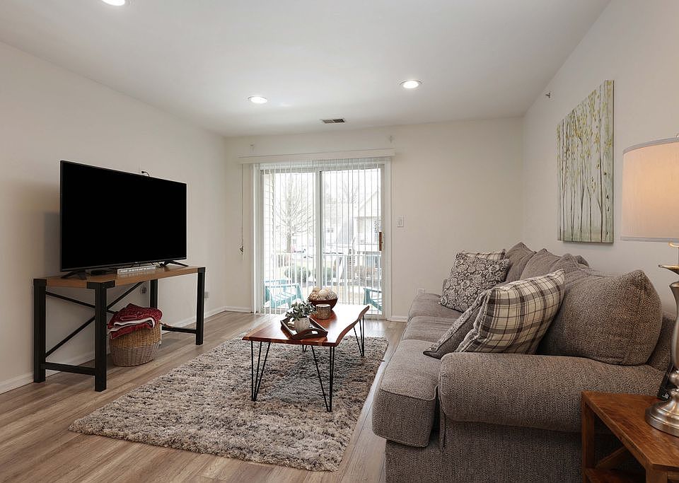 Charming living room with sliding doors to your own private deck that overlooks the courtyard