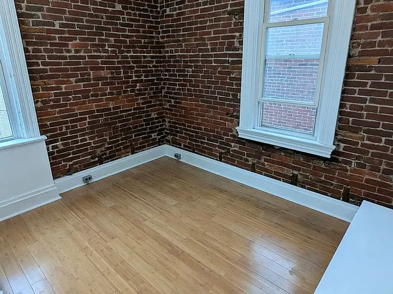 2nd Floor 3rd Bedroom w/ exposed brick, two windows one: overlookng the garden, the other: the alleyway, built-in closet & shelves, fabulous, natural bamboo floors