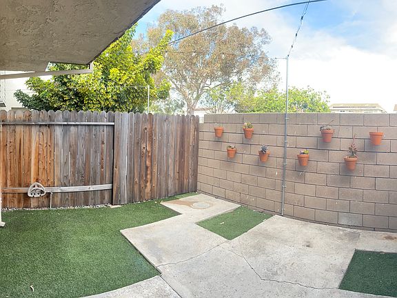 Private back yard/patio off living room. Space for BBQ and patio set. Fake grass. String lights overhead.