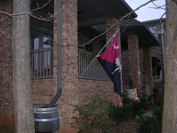The front exterior of the brownstone features a covered patio.