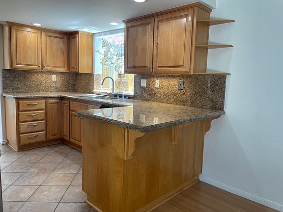 Remodeled kitchen with stainless steel appliances, newer cabinets, and granite countertops