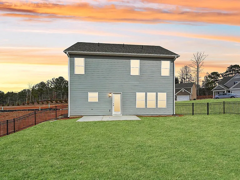 Rear view of the Alexander floor plan featuring a private patio and fenced yard.