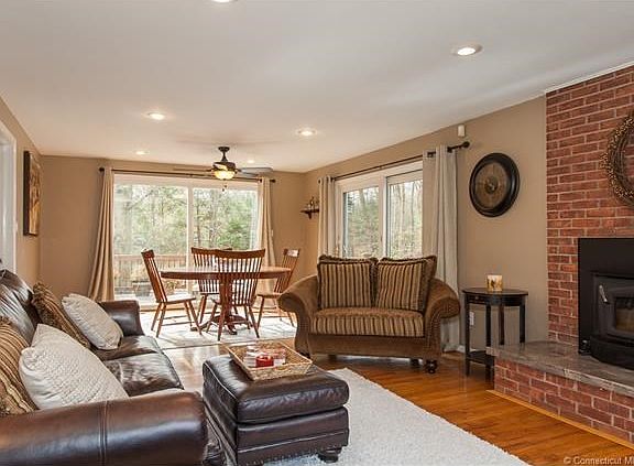 Large living room /dining room combo, from front to back of house, with lots of light and sliders  to deck