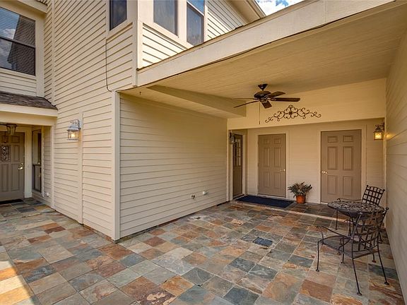 Here is another view of the covered patio and walkway from the garage to the kitchen area. There is also some storage here.
