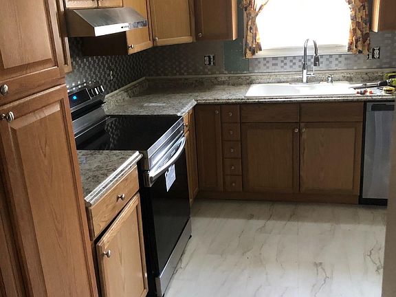Kitchen ( updated/new appliances, Floors, counters, cabinets) Large pantry on left.