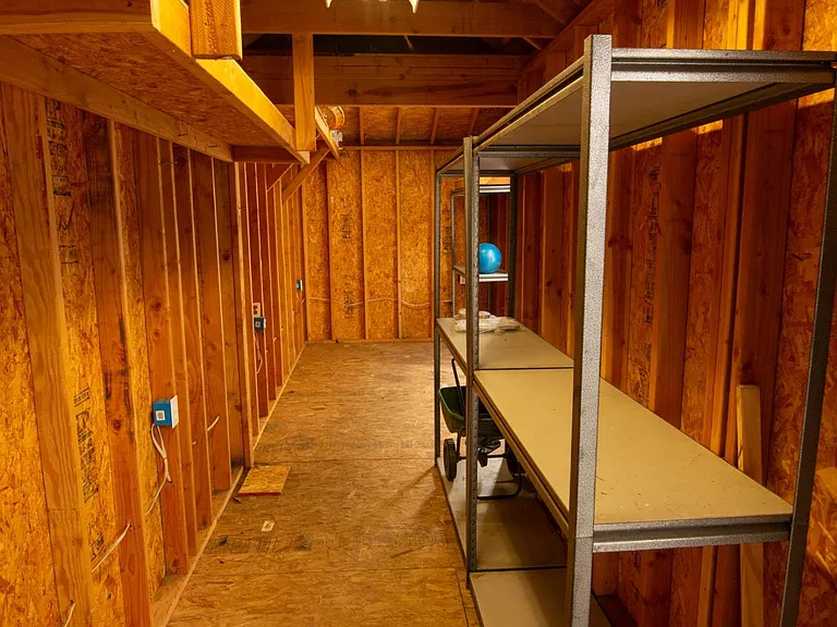 Inside the large shed...narrow but long. Furnished with industrial racks.