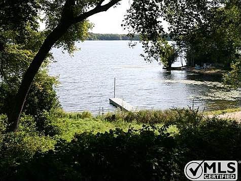 Property has lawn and vegetation down to the sandy beach