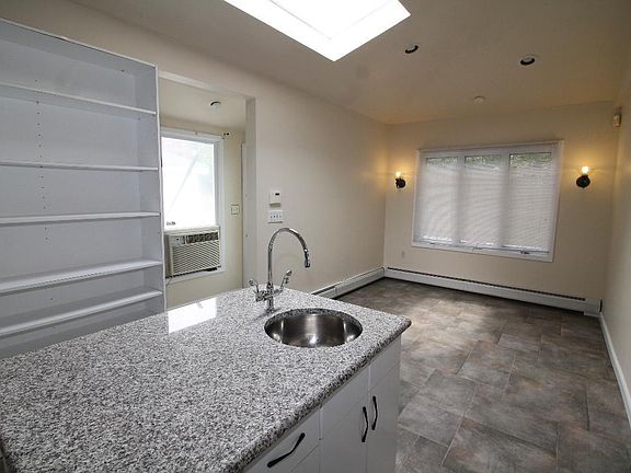 Kitchen island with skylight, high ceilings