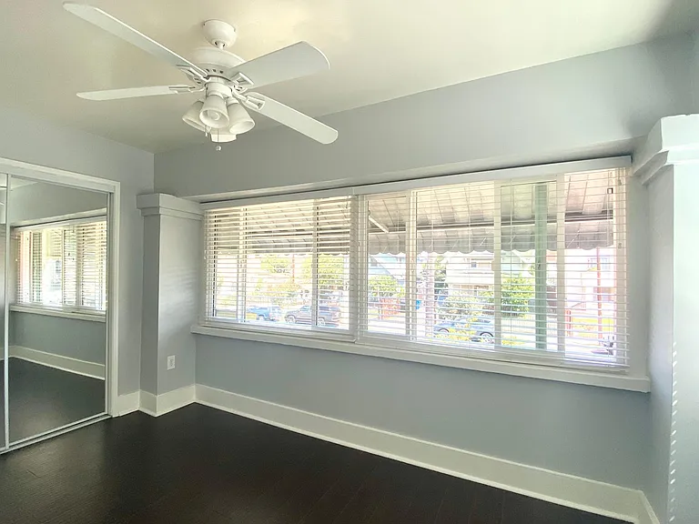 Spacious bedroom with large windows, plenty of natural sunlight