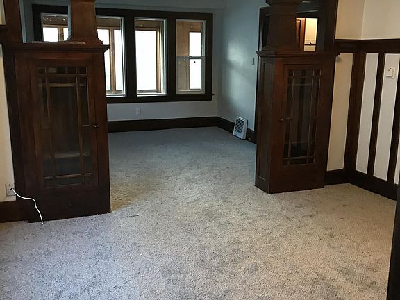 Dining room with new carpet and built-in china cabinets 