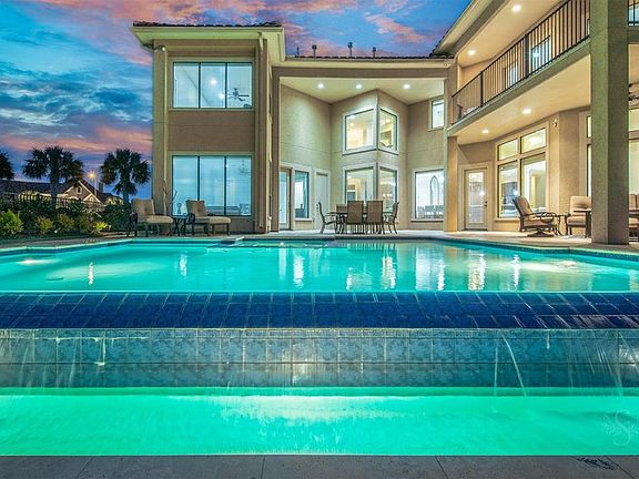 Luscious landscaping surrounds this home with large outdoor covered patio. Several patio seating areas and a large wrap around balcony giving you the beautiful views from various locations