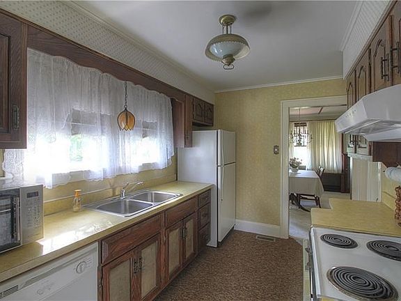 Galley Kitchen offers beams of sunlight and great counter space.  Very functional!