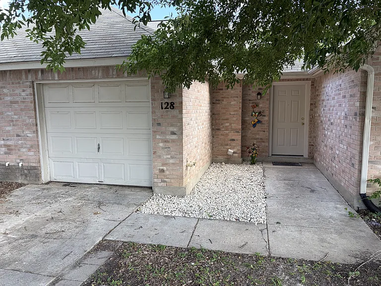 Single car garage and driveway, entry courtyard and front door
