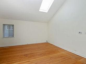 Living room has vaulted ceiling with skylight