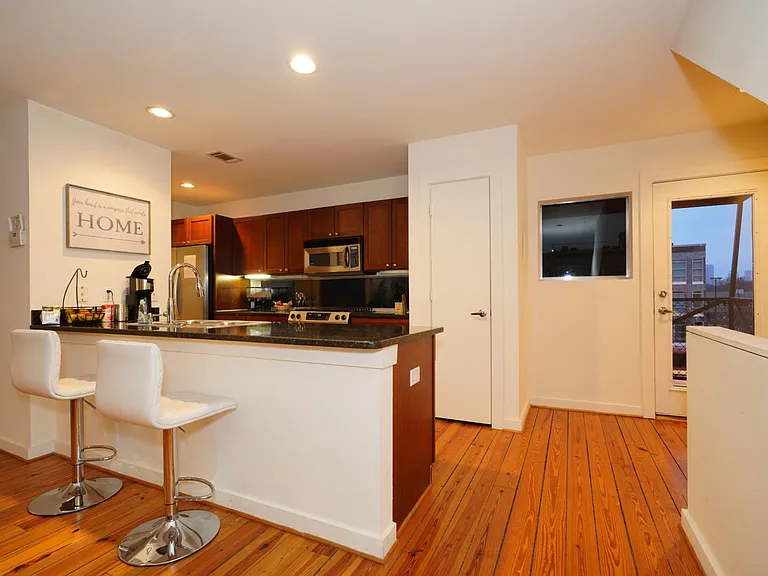 Bar area at the kitchen counter and glass door to the balcony