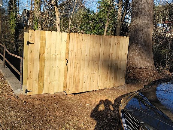 Fence and gate access to stairs leading to backyard