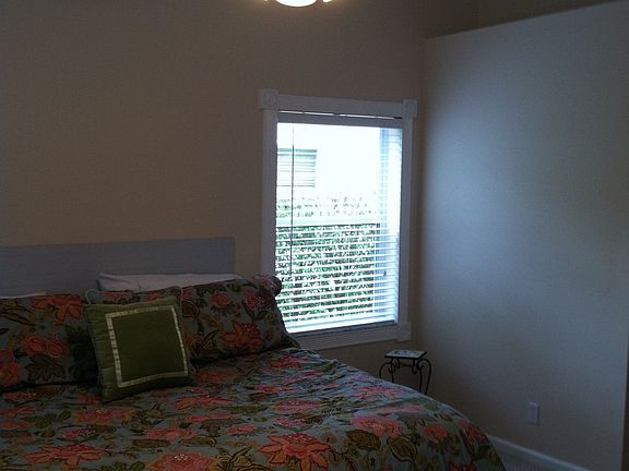 master bedroom is spacious and neutral with a vaulted ceiling