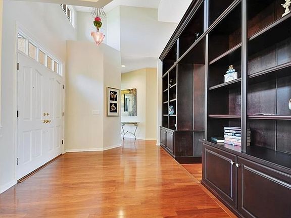 Double door entry with mahogany bookcase