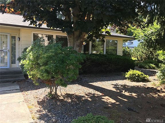 Front yard has western exposure and benefits from established shade trees and native plants.