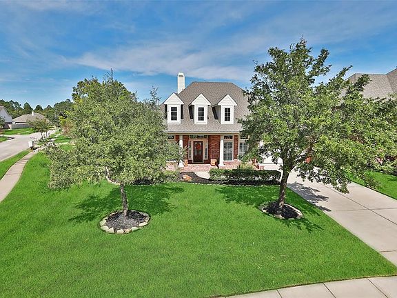 Excellent curb appeal with mature trees and lush landscaping