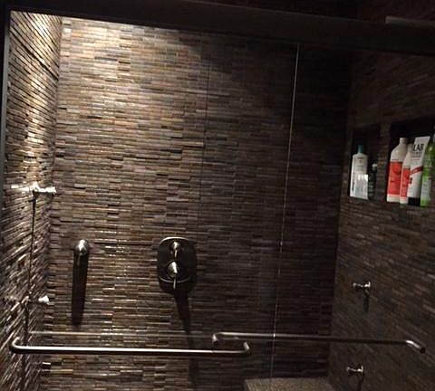 Master bedrooms's bathroom natural stone shower with body sp