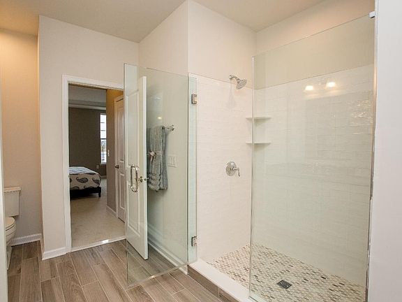 The first-floor master bedroom suite features a lavish bathroom and walk-in closet
