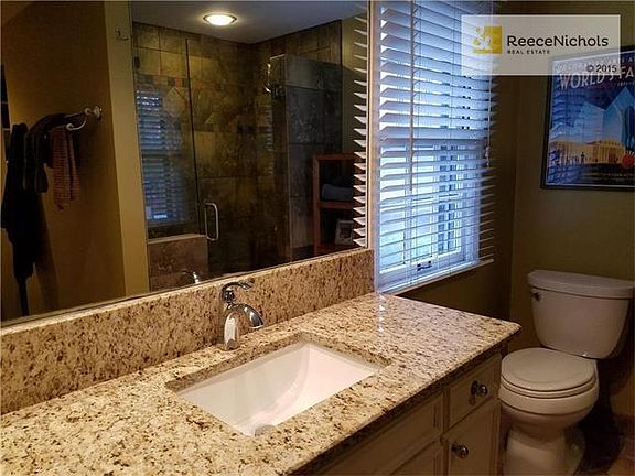 Brand new granite draws you into the spacious master bathroom.