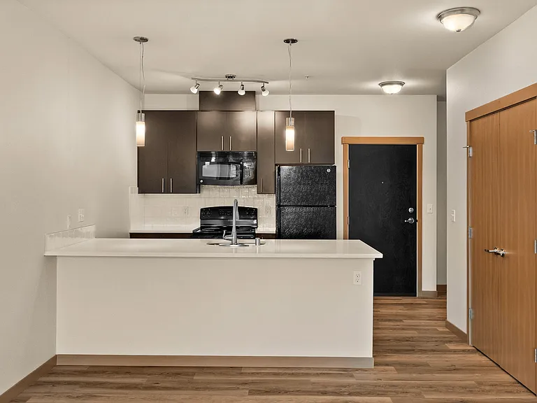 Whip up something delicious in this stylish kitchen_complete with a center island, sleek dark cabinets, and plenty of counter space. Whip up something delicious in this stylish kitchen_complete with a center island, sleek dark cabinets, and plenty of coun