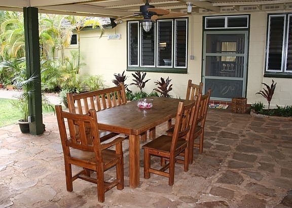 Large outdoor lanai overlooks a lush garden