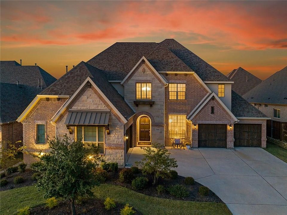 Picture perfect drive up appeal with large driveway for extra parking or kids to play, professional landscaping with uplights and brick and stone mix to create such a warm and inviting home.