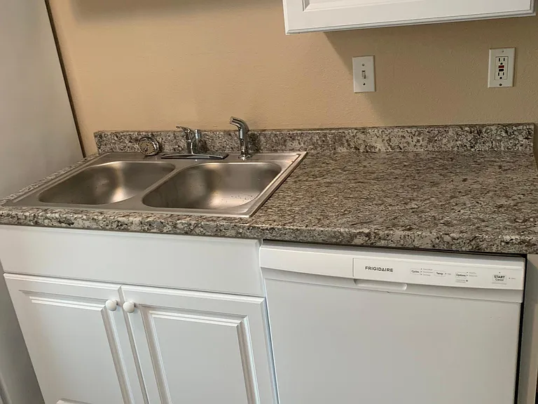 Brand new dishwasher, sink, cabinets, countertops and flooring