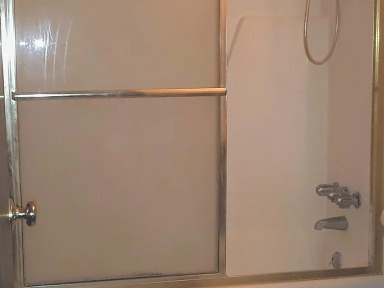 Bath with designer sliding glass doors on tub shower combination