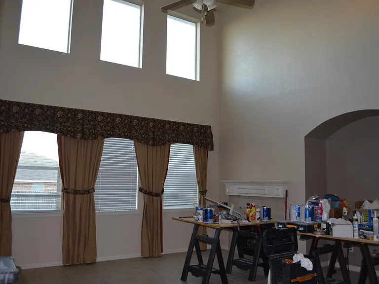 High ceiling living room with fire place