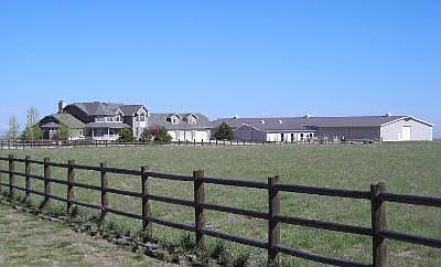 Looking at the house and barn/arena as you drive down the driveway