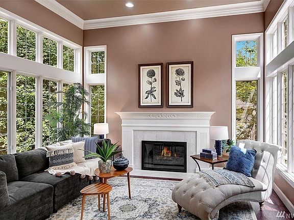 Refinished dark hardwood floors grace the entire home both upstairs and down. The wainscoted foyer leads to the columned formal 