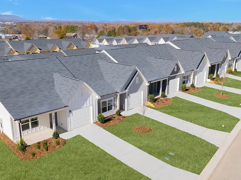 Aerial shot of the ranch-style, cottage homes with private driveways and attached garages.
