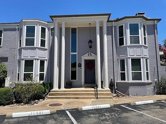 Greek revival house with brick siding and uncovered parking