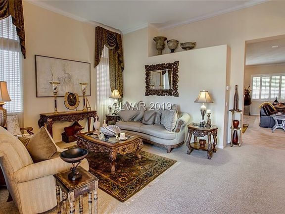 Enter into Formal Living Room with dramatic 12-foot high ceilings and crown molding throughout home.  Lots of windows allow for good natural lighting.  Furnishings are negotiable.