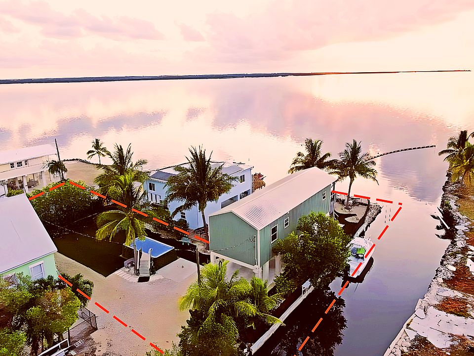 Double lot with pool, big yard and 100' of canal boat access to Gulf and Atlantic