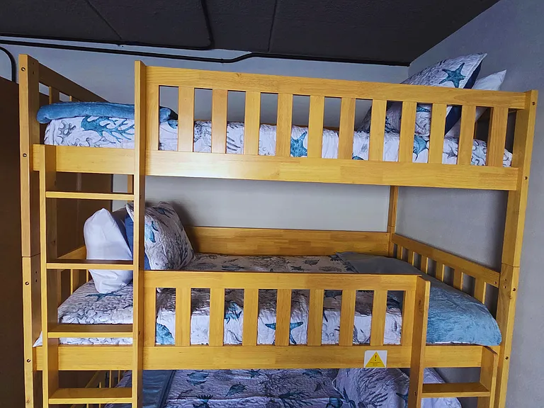 Cozy bunk for three with high-quality linens and pillows.