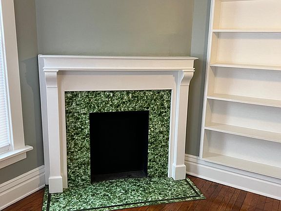 Den with ornamental fire place and built in bookcase